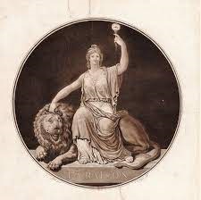 Une statue de la Déesse de la Raison. Elle est assise sur un lion, avec la main droite posée sur le lion et la main gauche levée en brandissant une torche